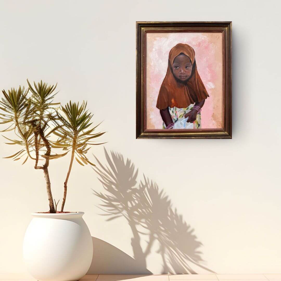 What She Carries original oil painting of a Ugandan girl displayed on a sunlit wall beside a potted plant