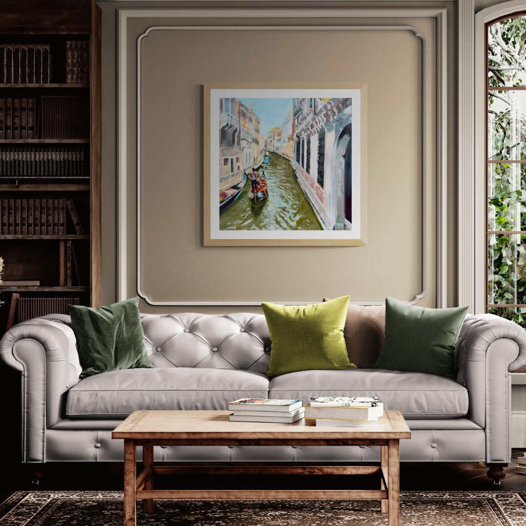 Living room with grey sofa, wooden coffee table, and framed Venice gondola artwork on the wall.