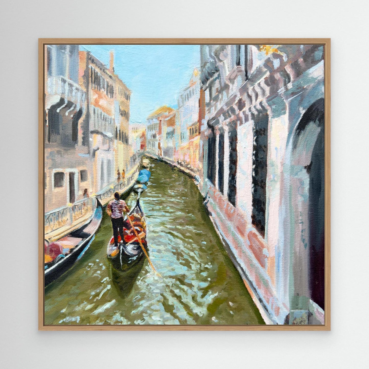 Framed painting of a Venice canal scene with gondolas and buildings.