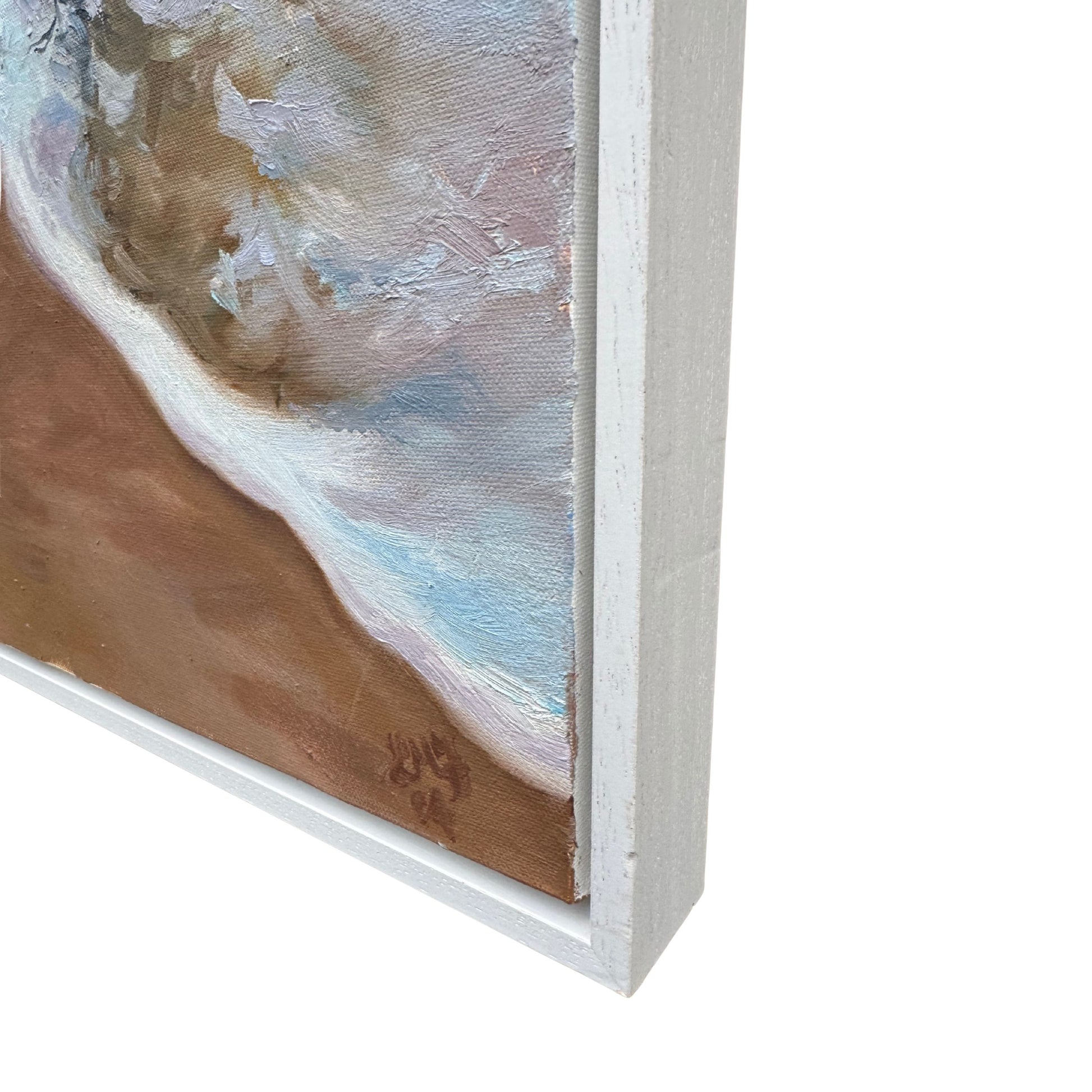 Close-up corner detail of white wooden frame on original Cornwall seascape painting.