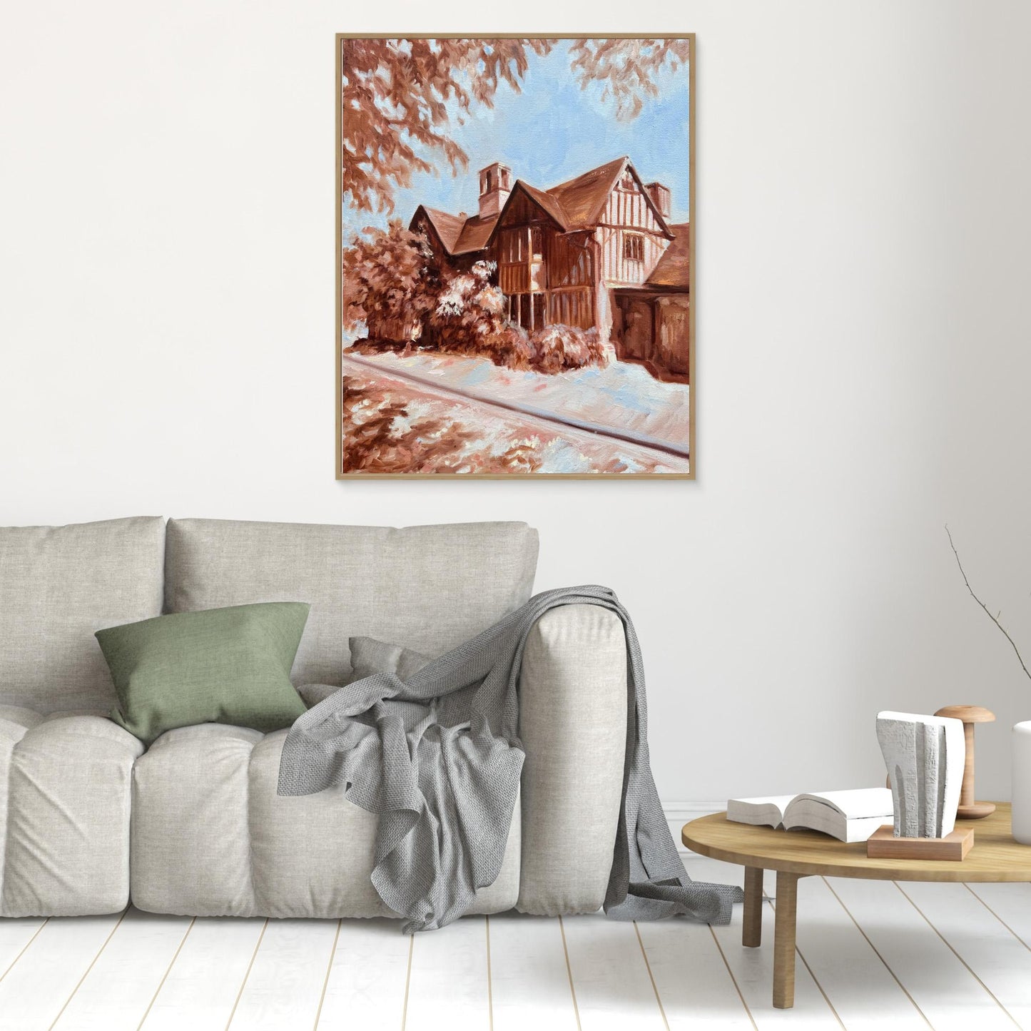 Hall’s Croft canvas print in oak frame hung above a sofa in a warm, traditional living space.