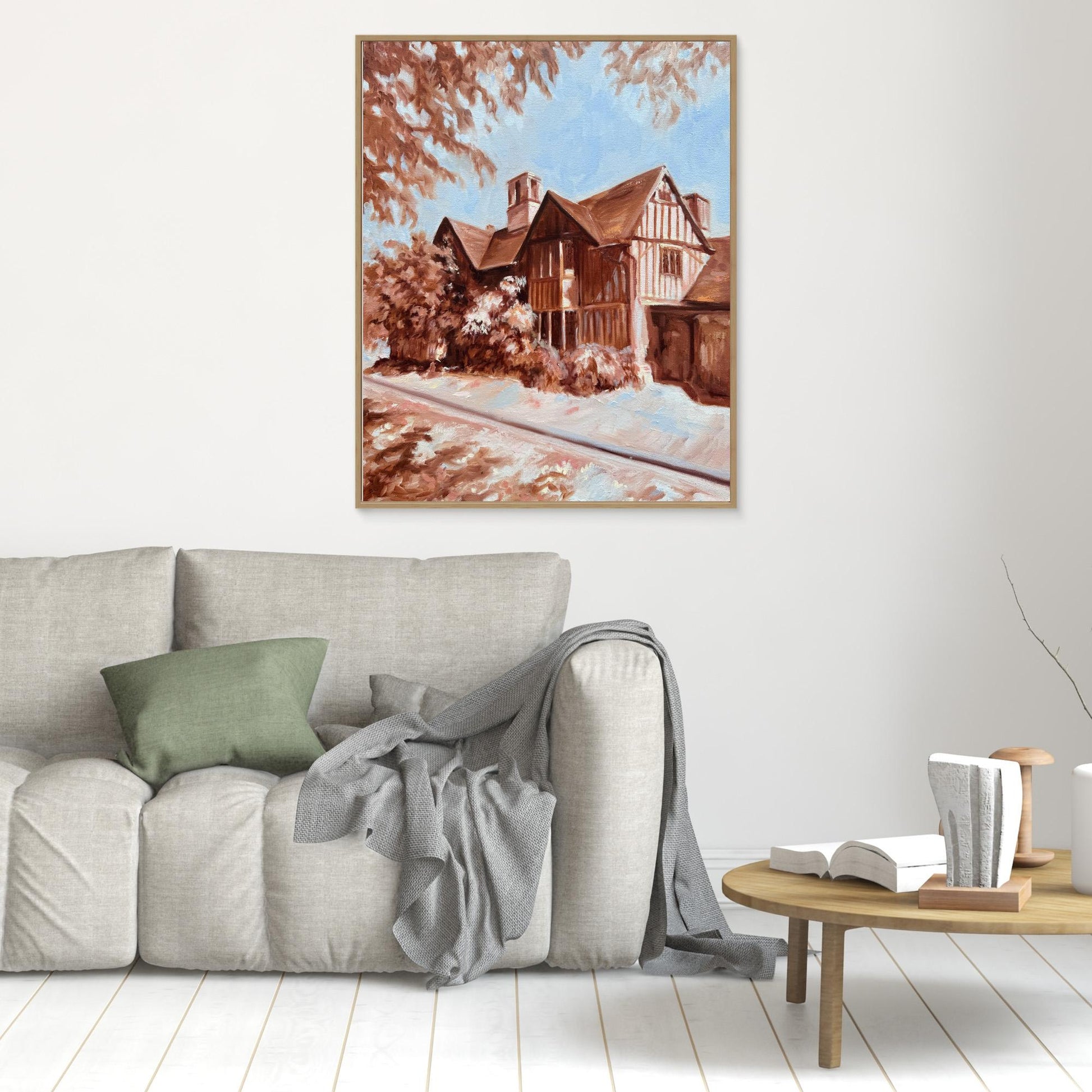 Hall’s Croft canvas print in oak frame hung above a sofa in a warm, traditional living space.