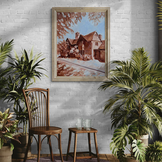 Framed original oil painting of Hall’s Croft in Stratford-upon-Avon displayed on a white brick wall with plants.