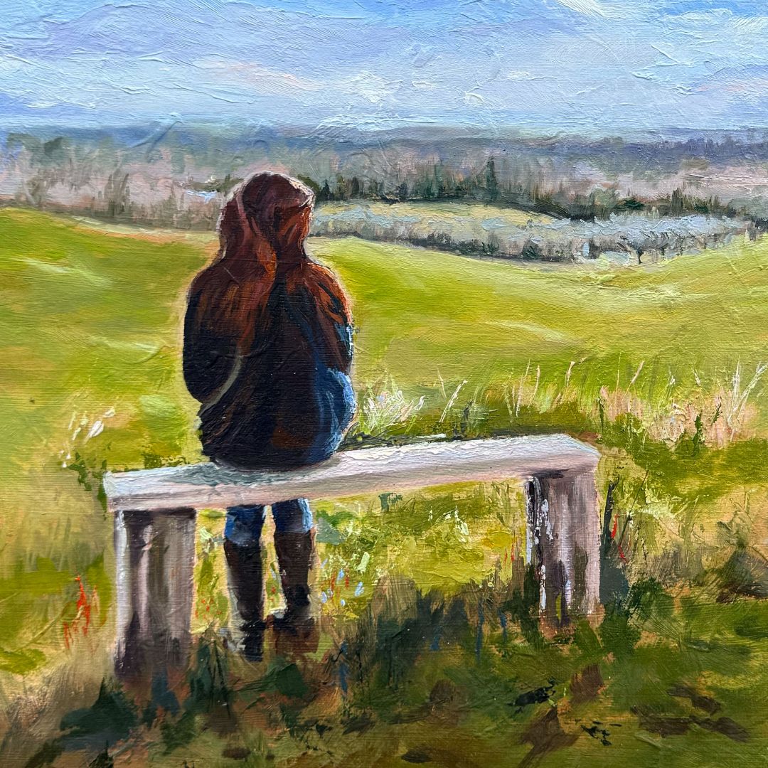 Close-up detail of If These Fields Could Talk by Lorraine Field, featuring a solitary figure seated on a weathered bench overlooking green fields.