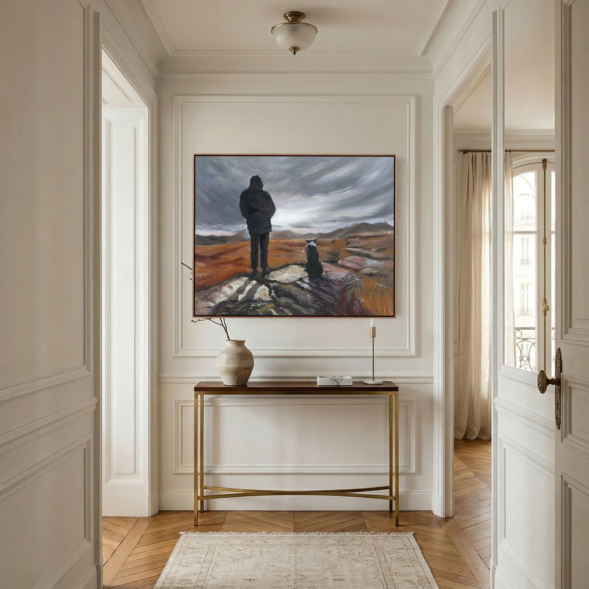 Man and His Border canvas print above a slim console table in a light interior with wall panelling.