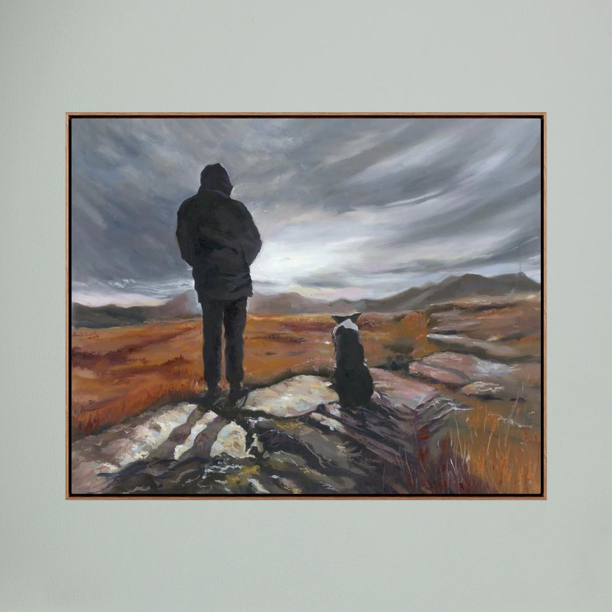 Man and His Border canvas print in a dark oak frame, depicting a man and his Border Collie looking across a rugged landscape.