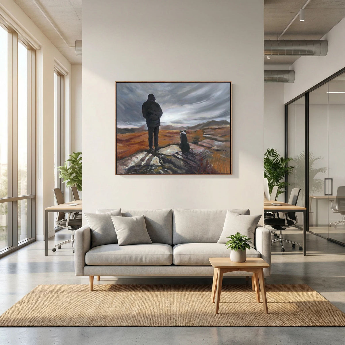 Man and His Border canvas print by Lorraine Field above a grey sofa, depicting a man and his Border Collie overlooking rugged countryside beneath a cloudy sky.