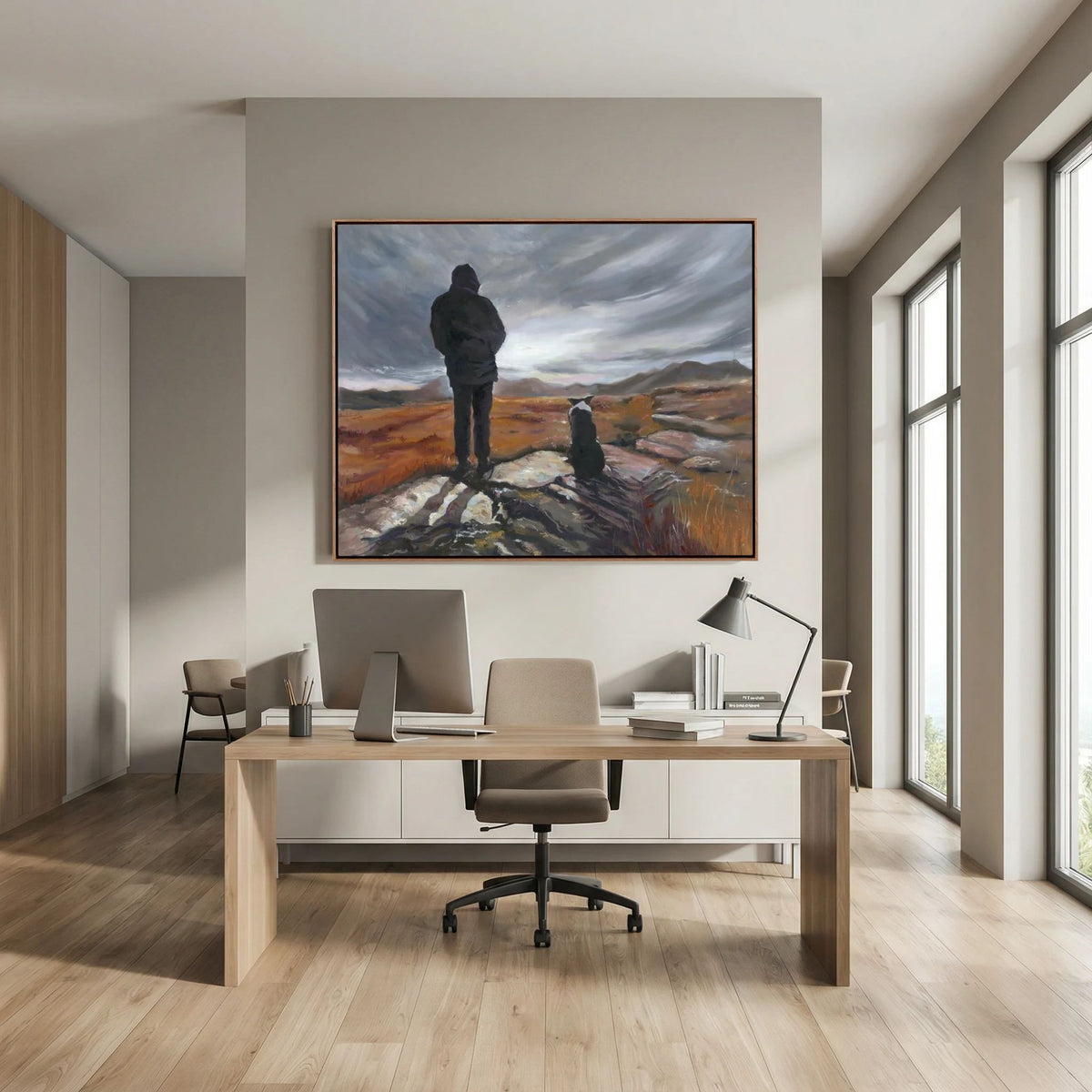 Man and His Border canvas print above a desk in a modern office with large windows and two chairs.
