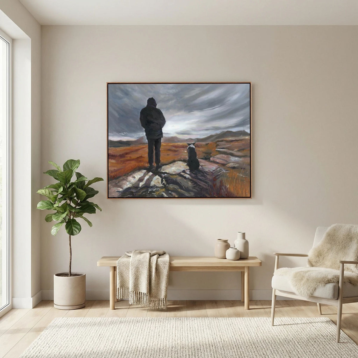 Man and His Border canvas print above a cream sofa beside a leafy plant in a neutral living room.