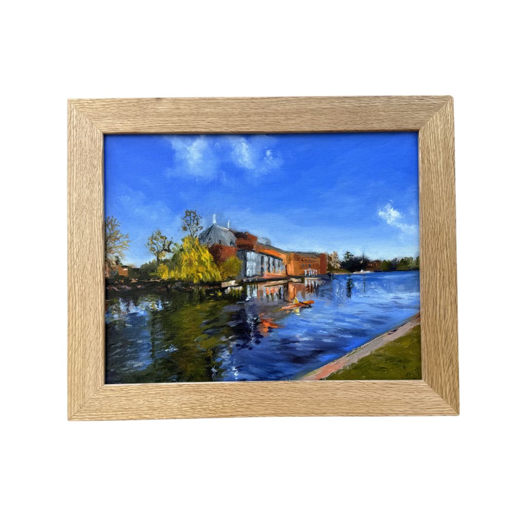 Original oil painting of Stratford-upon-Avon theatre reflected in the River Avon by Lorraine Field Art, shown in a natural wooden frame (frame not included)