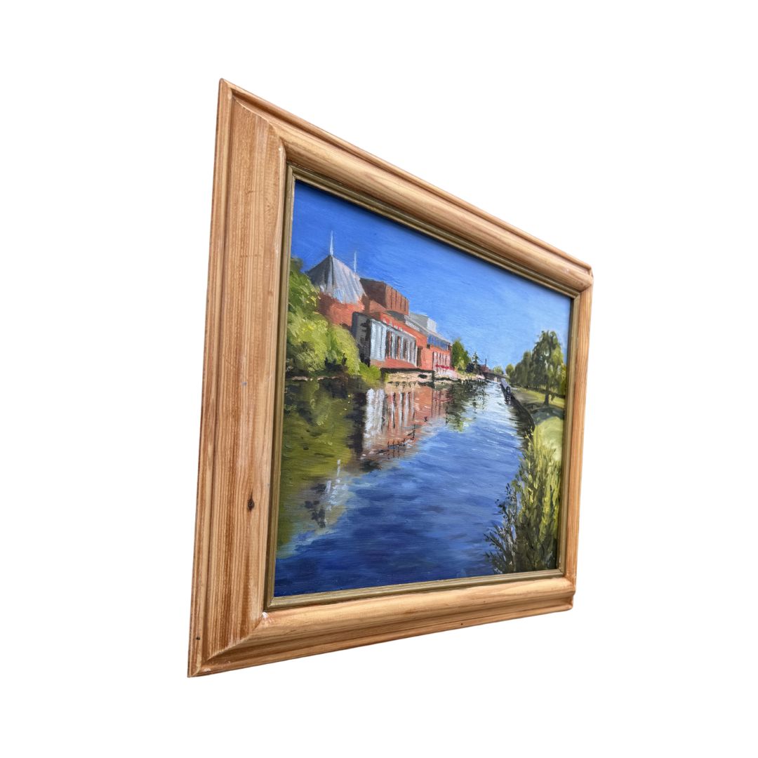 Side view of a framed original oil painting depicting the Royal Shakespeare Theatre and River Avon in Stratford-upon-Avon.