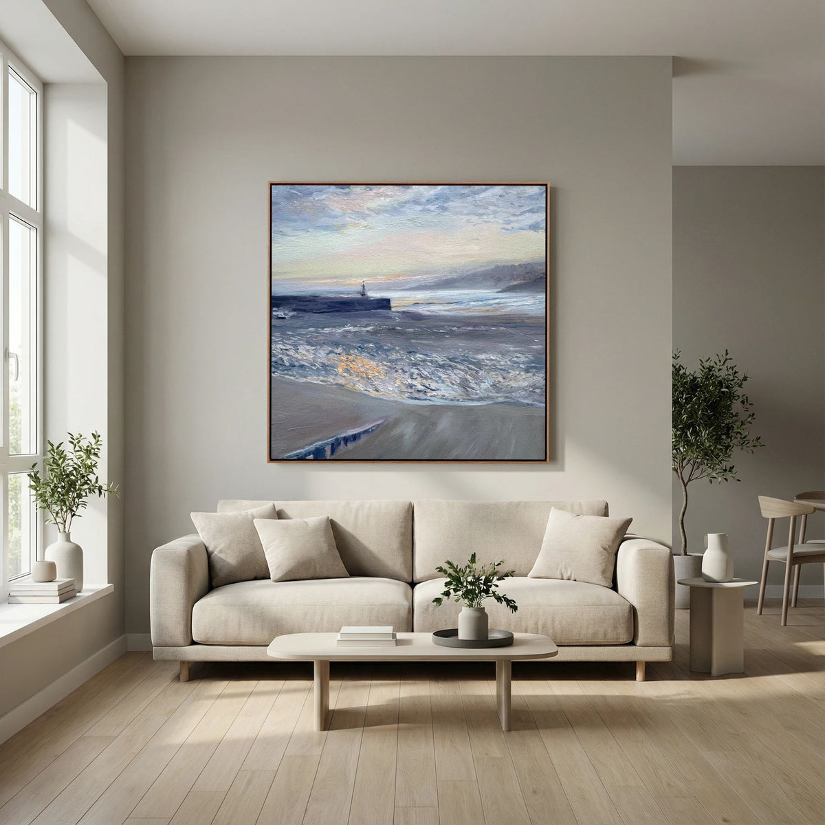 St Ives Harbour Sunrise canvas print by Lorraine Field displayed above a cream sofa in a light living room.
