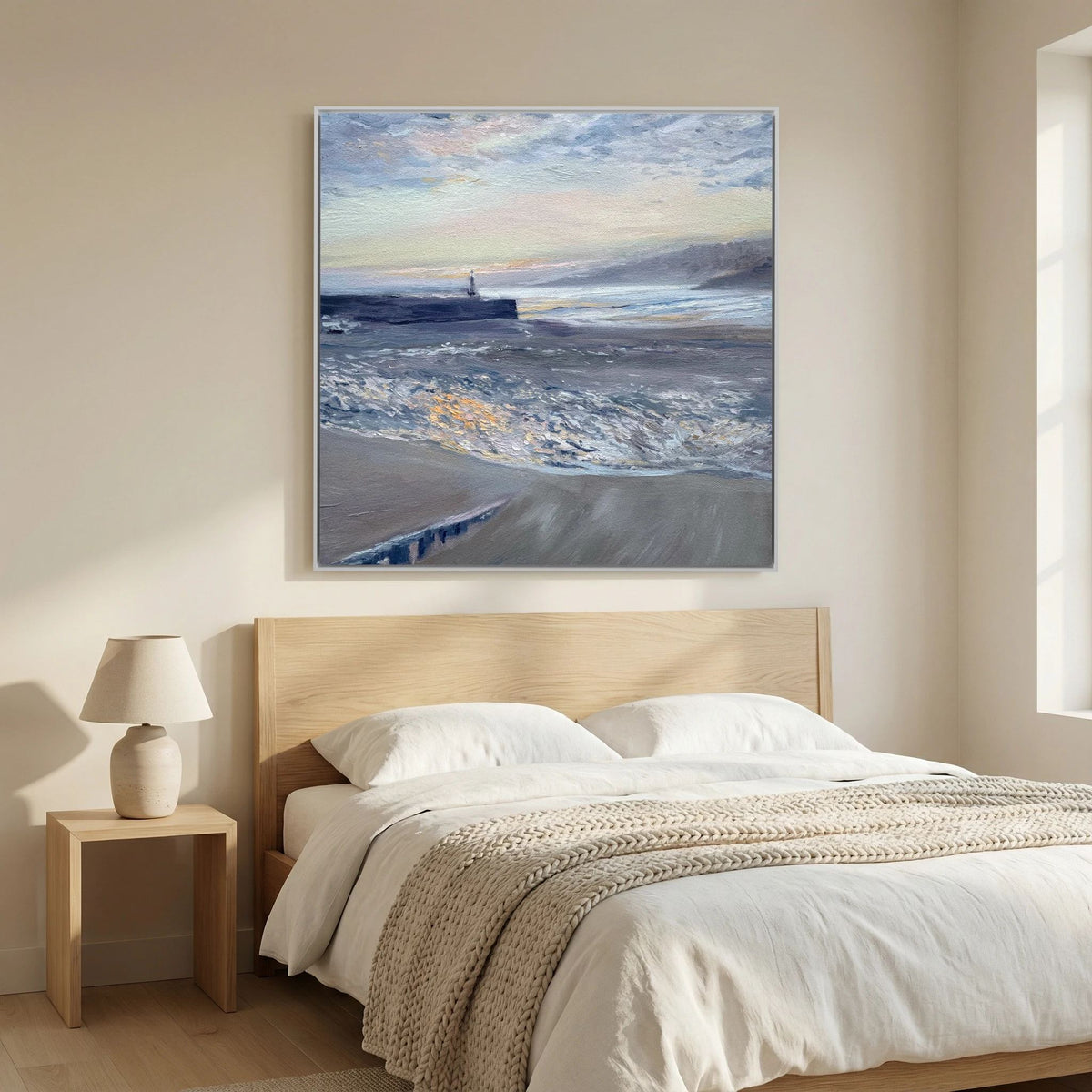 St Ives Harbour Sunrise canvas print displayed above a bed with cream bedding in a light bedroom.