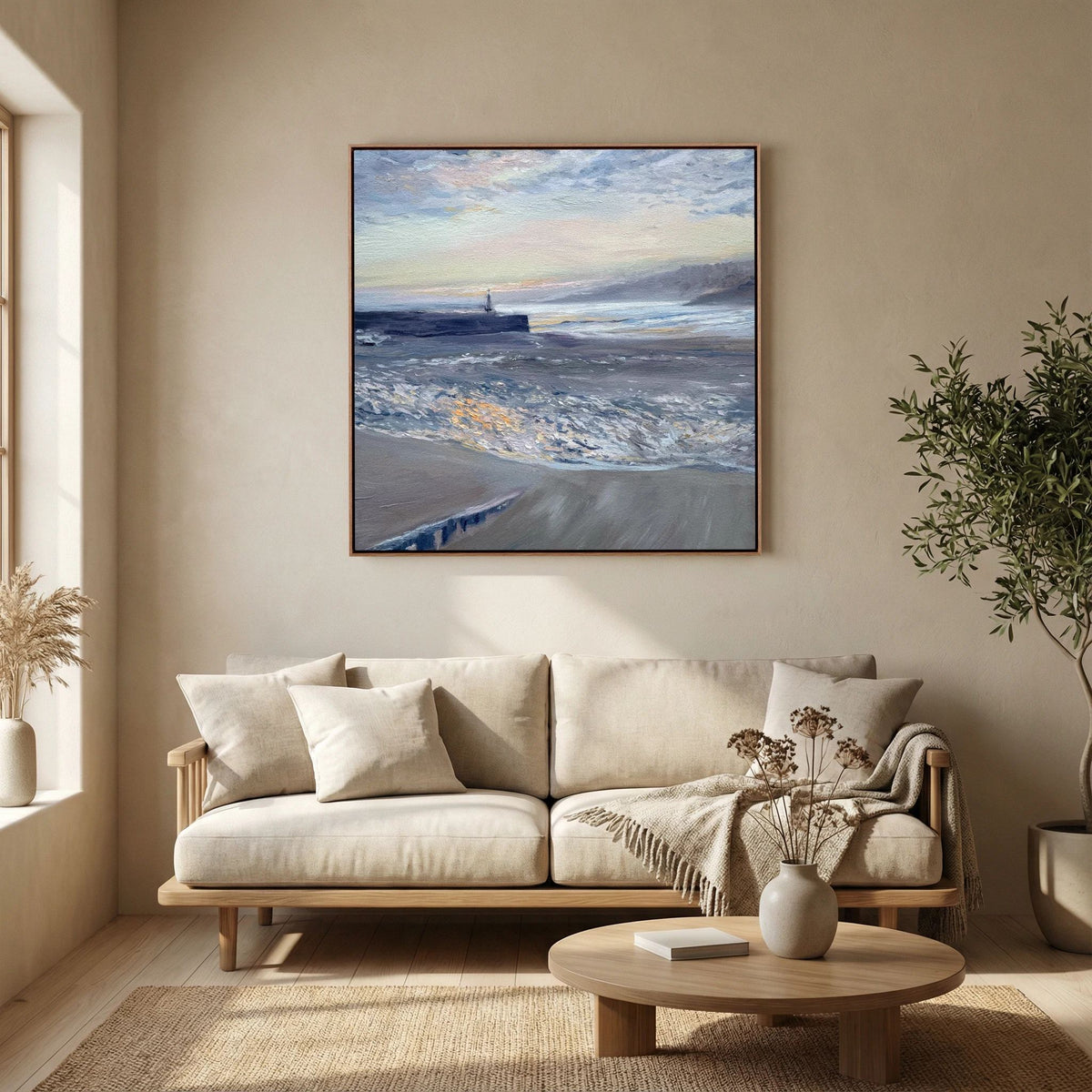 Framed St Ives Harbour Sunrise canvas print above a cream sofa with a glass coffee table in front.