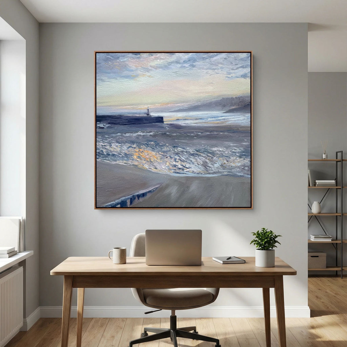 Framed St Ives Harbour Sunrise canvas print displayed above a wooden office desk beside a window.