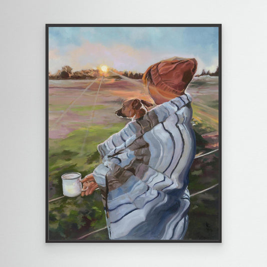 Framed canvas print of Sunrise with the Pup in black, a soulful artwork of a lady and her jack russell gazing at sunrise over open fields.