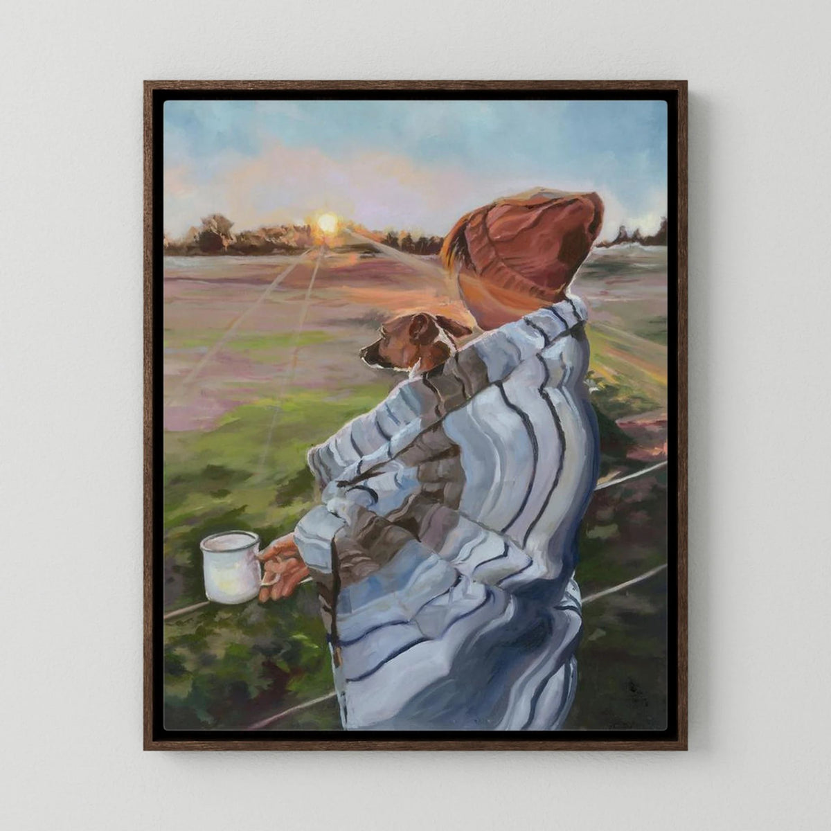 Sunrise With the Pup canvas print in a dark oak frame, showing a person holding a small dog against a softly lit coastal landscape.
