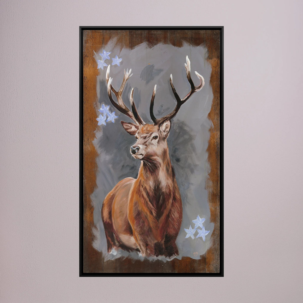 The Stag red deer canvas print shown in a black frame on pink wall