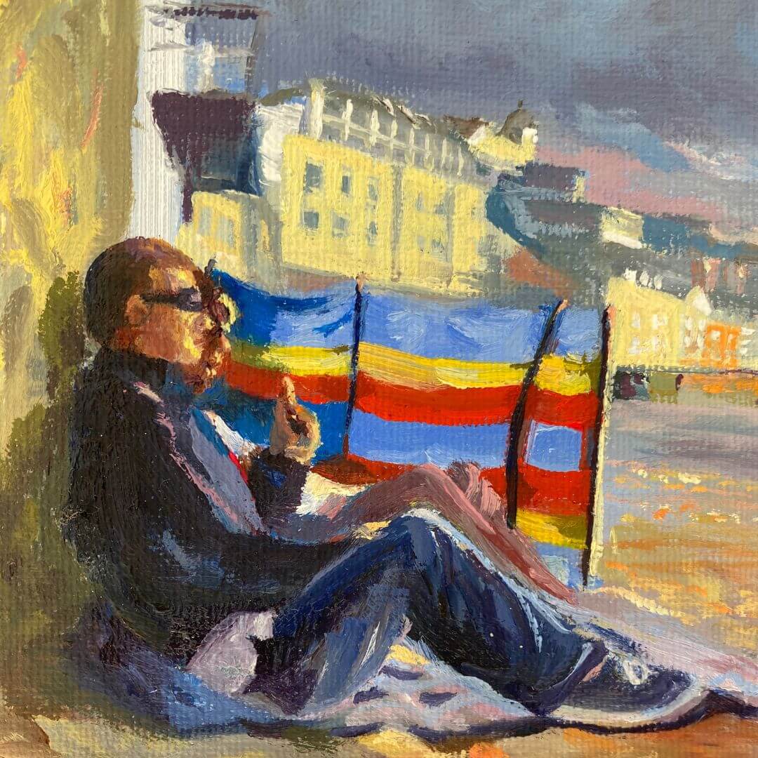 Detail of a seated adult beside colourful beach windbreaks on Porthmeor Beach in Will You Play?, an oil painting by Lorraine Field.