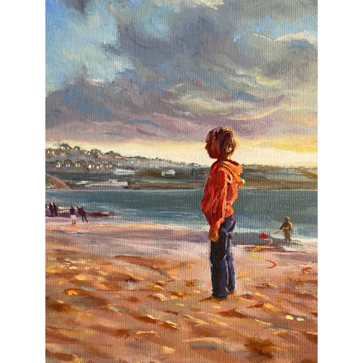 Close-up detail of figures standing on Porthmeor Beach in warm evening light.