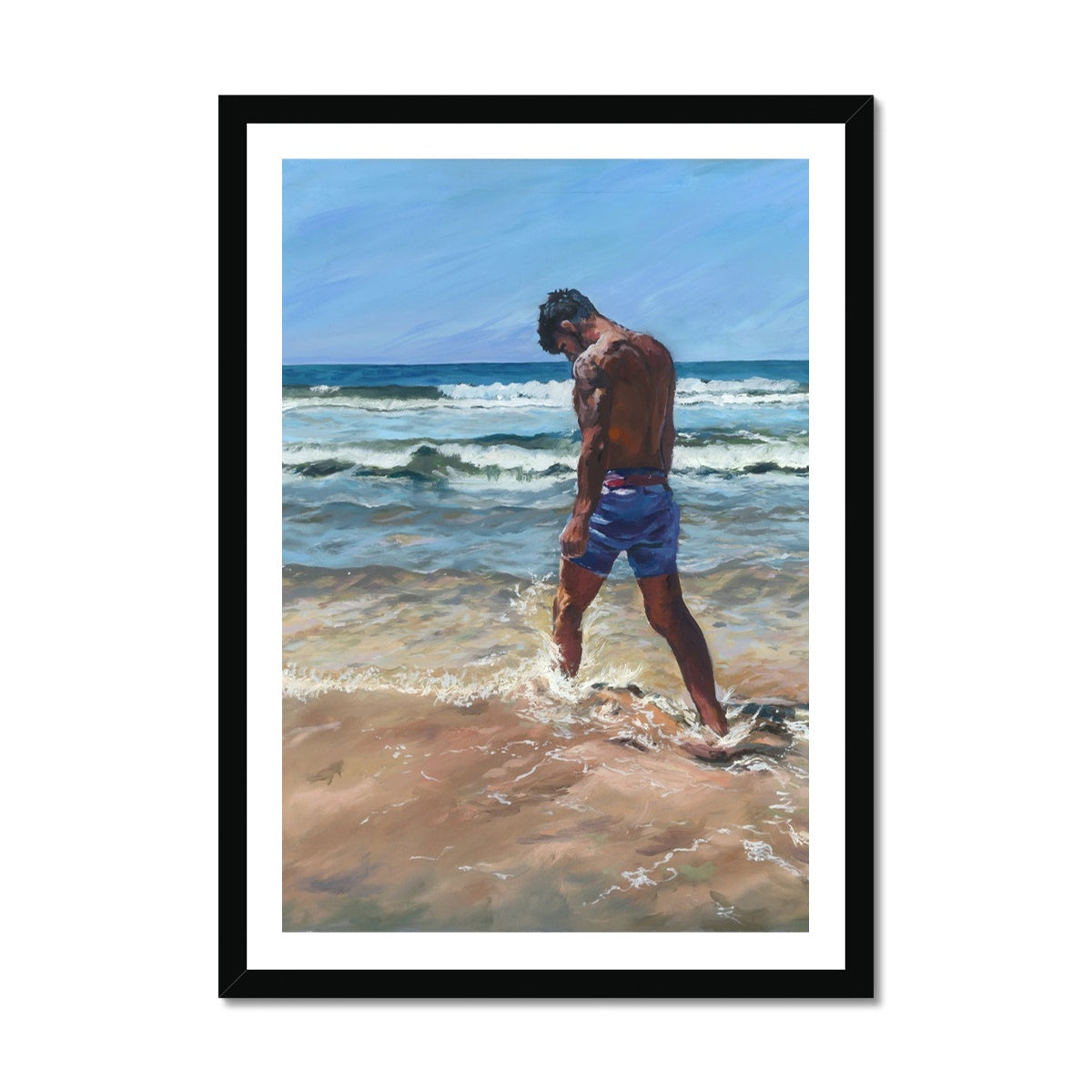 Emotional coastal fine art print of a solitary man walking through surf on a Cornwall beach, presented in a black frame. Moody seaside wall art for contemporary interiors.