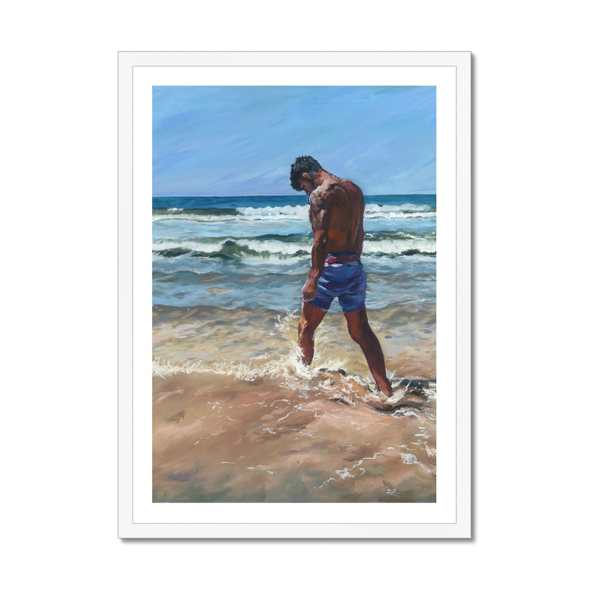 Coastal fine art print of a lone figure walking beside the sea in Cornwall, framed in white. Calm emotional beach wall art for light and airy interiors.