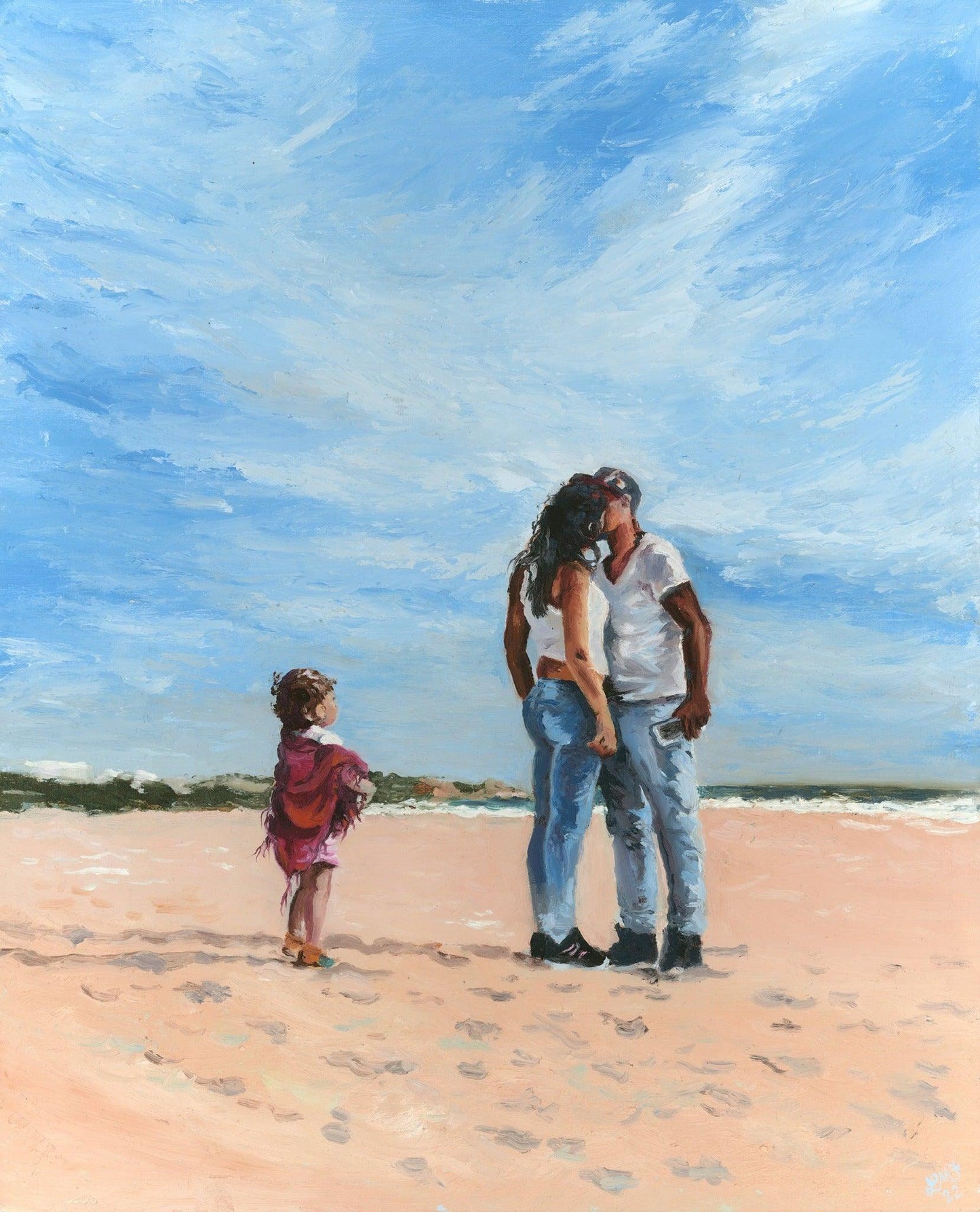 A young couple kissing on a beach with a little girl beside them dressed in cerise pink shawl, looking up at her Mother